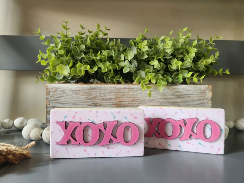 XOXO with Patterned Arrows Background