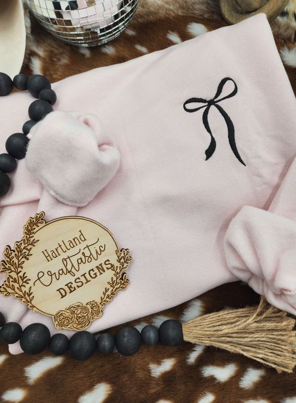 Light Pink Pullover with Embroidered Black Bow Pocket Design
